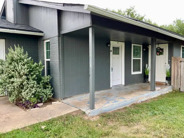 a view of a house with potted plants