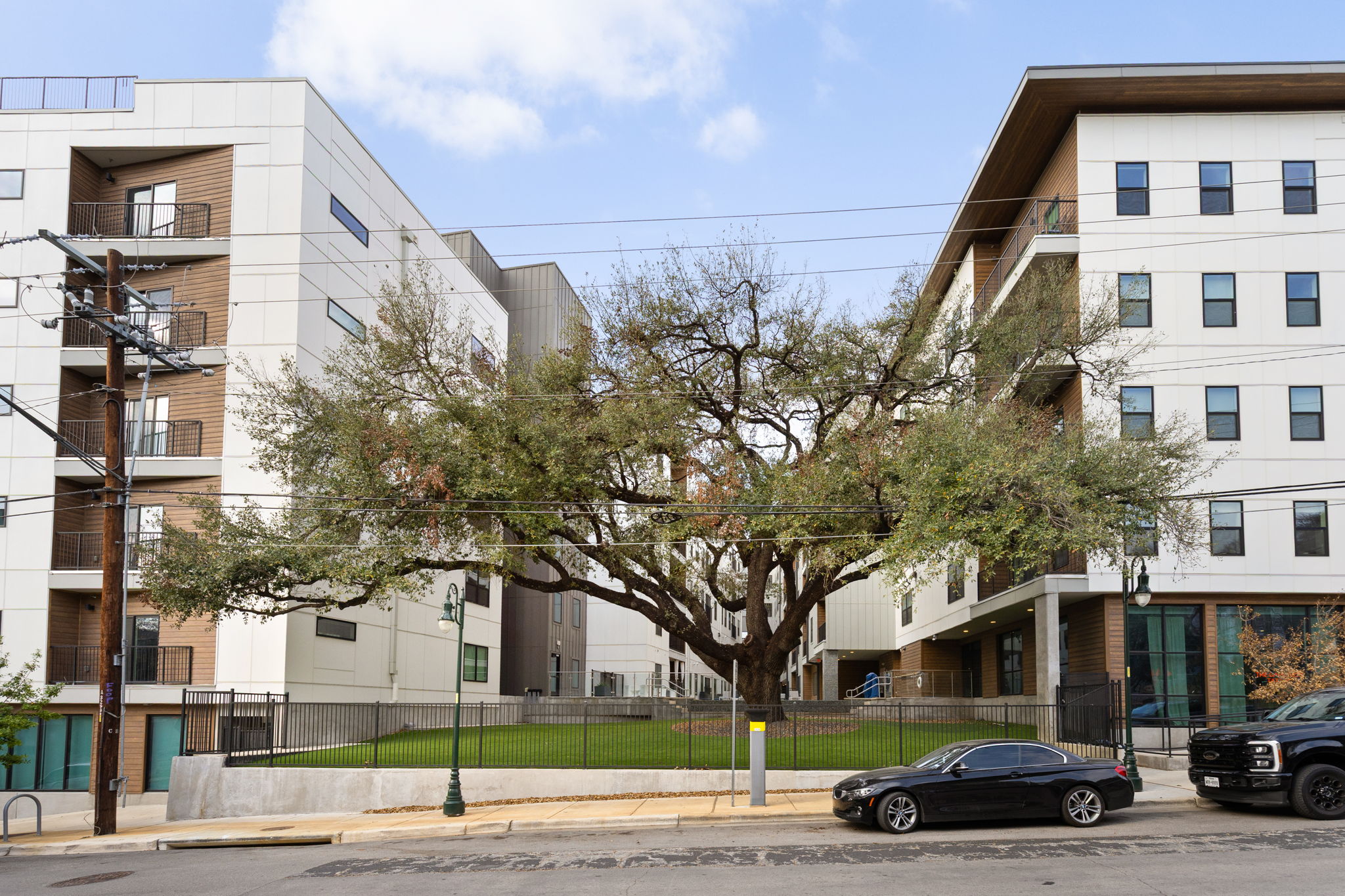 View of apartment building / complex featuring a fenced front yard