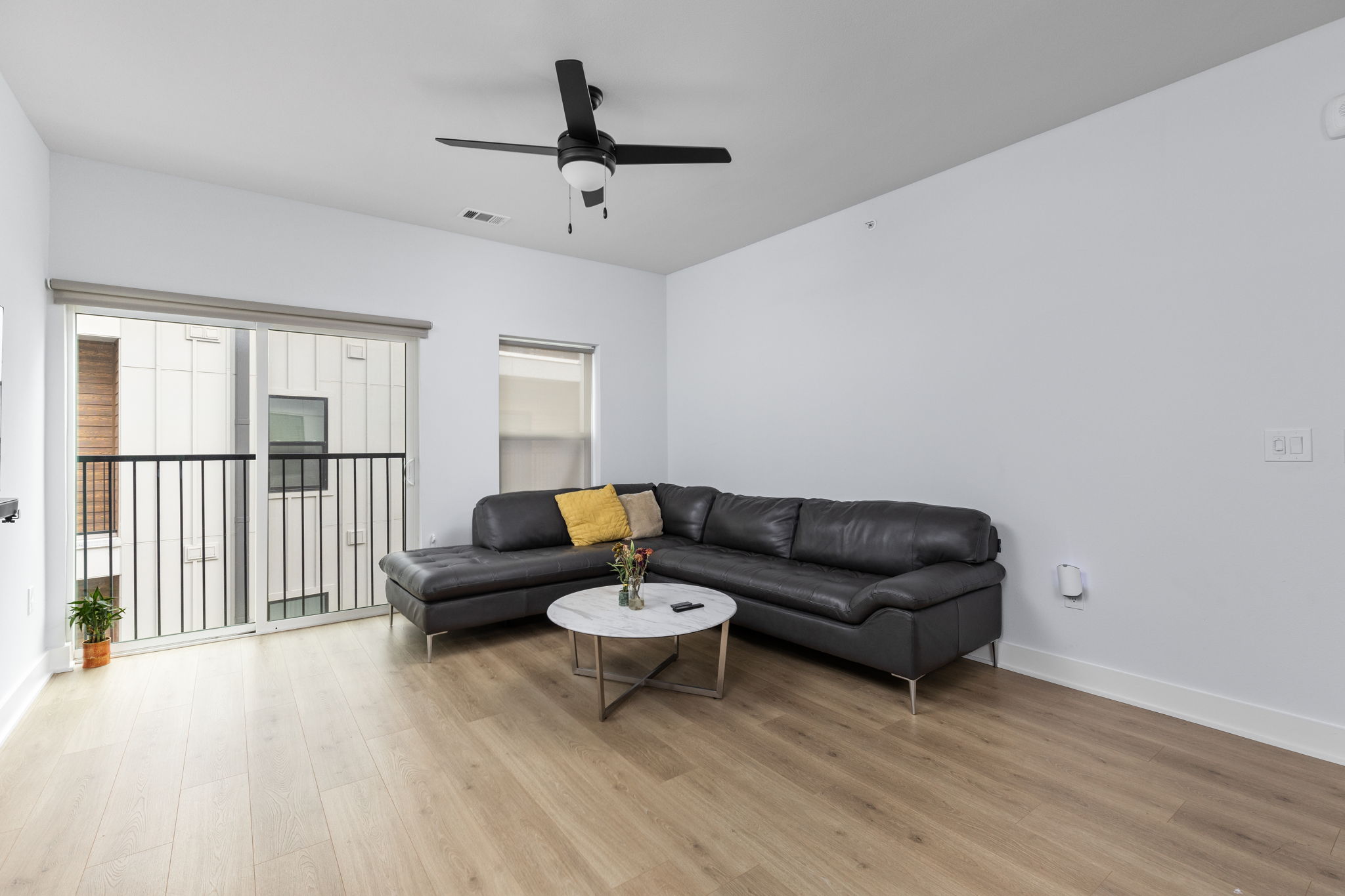 2500 Longview Street, Unit 405 Austin, TX 78705 - Photo 9 of 28 Living area with light wood-style floors and ceiling fan