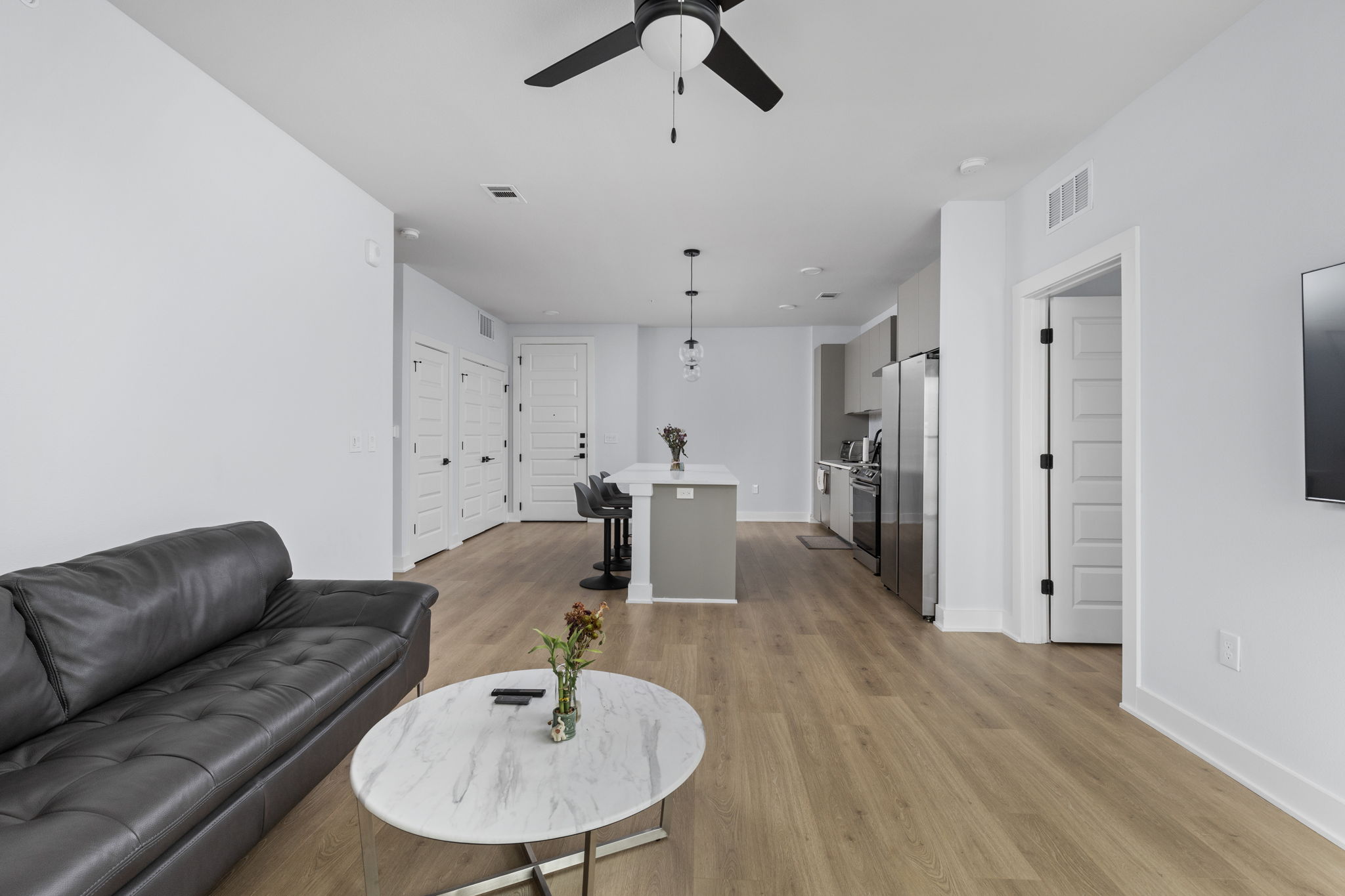 2500 Longview Street, Unit 405 Austin, TX 78705 - Photo 10 of 28 Living room with ceiling fan and light wood-style flooring