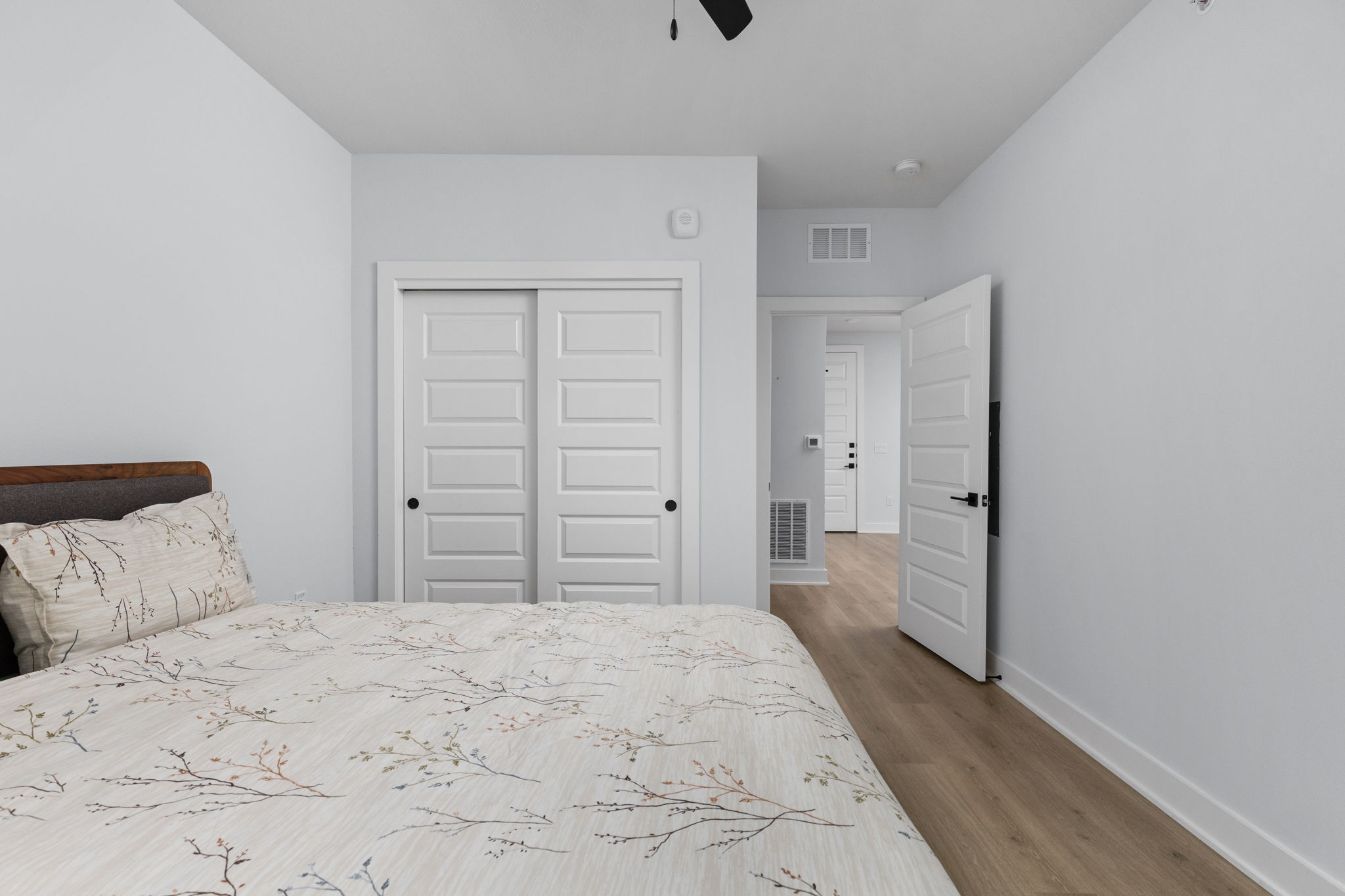 2500 Longview Street, Unit 405 Austin, TX 78705 - Photo 17 of 28 Bedroom with a closet, light wood-style floors, and a ceiling fan