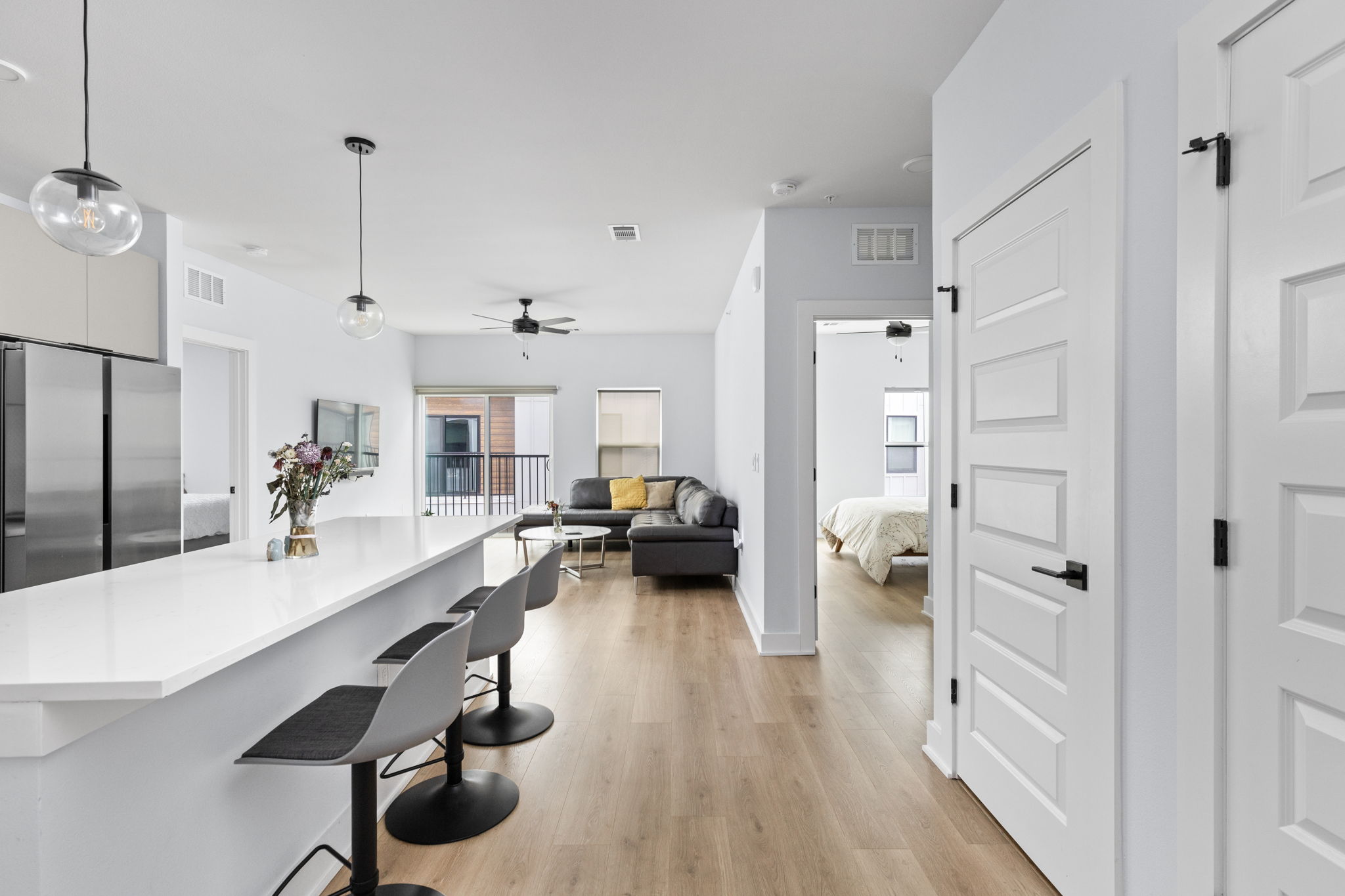 2500 Longview Street, Unit 405 Austin, TX 78705 - Photo 27 of 28 Kitchen featuring freestanding refrigerator, pendant lighting, a breakfast bar area, light wood-style floors, and open floor plan