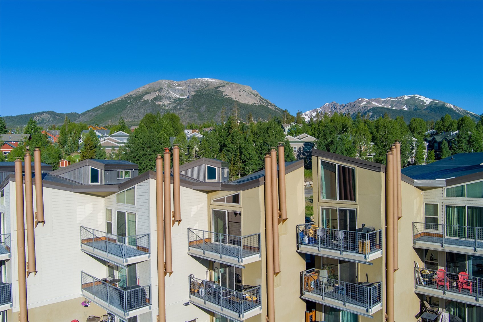 7031 Ryan Gulch Road, Unit 301 Silverthorne, CO 80498 - Photo 32 of 37 a front view of a house with a yard