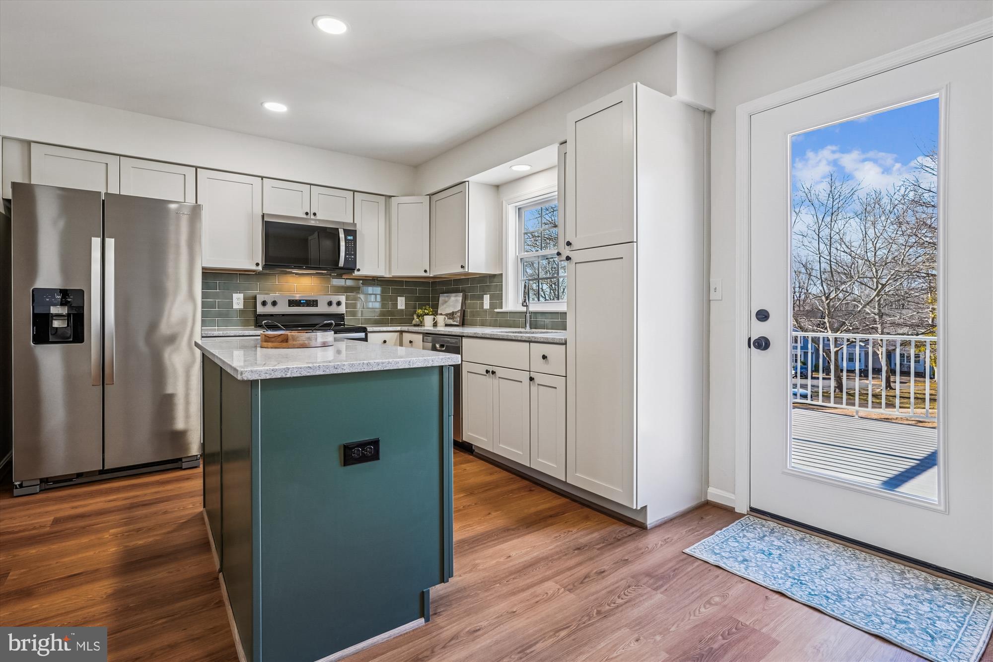 5146 Spring Branch Boulevard Dumfries, VA 22025 - Photo 11 of 38 a kitchen with stainless steel appliances granite countertop a refrigerator a stove top oven a sink and dishwasher with wooden floor