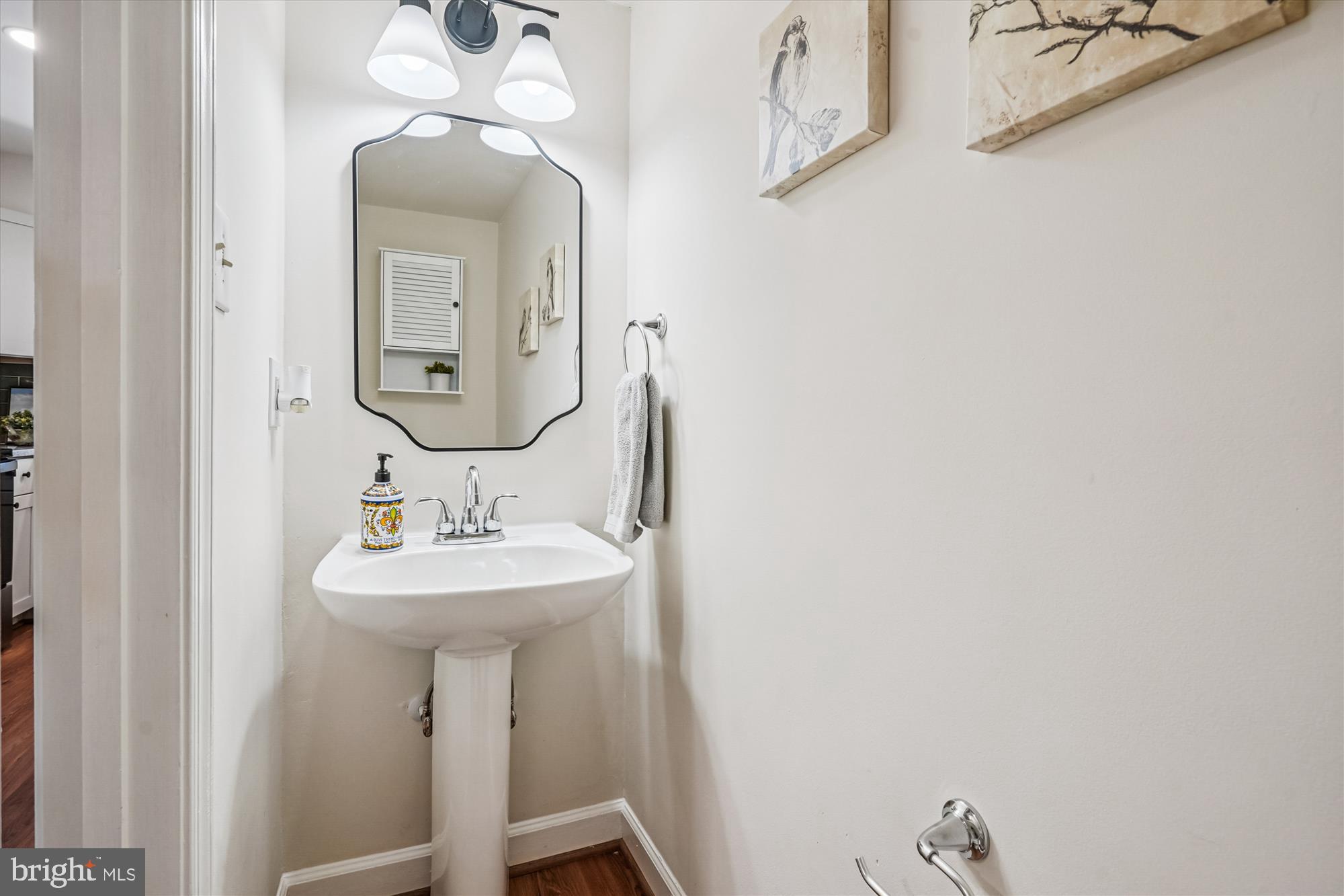 5146 Spring Branch Boulevard Dumfries, VA 22025 - Photo 14 of 38 a bathroom with a sink a mirror and vanity