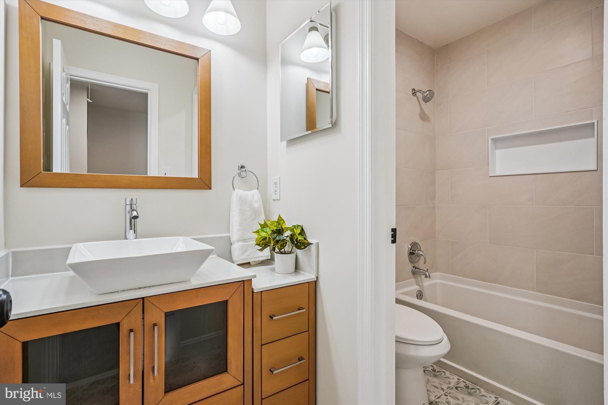 5146 Spring Branch Boulevard Dumfries, VA 22025 - Photo 21 of 38 a bathroom with a granite countertop sink toilet a large mirror a vanity and bathtub