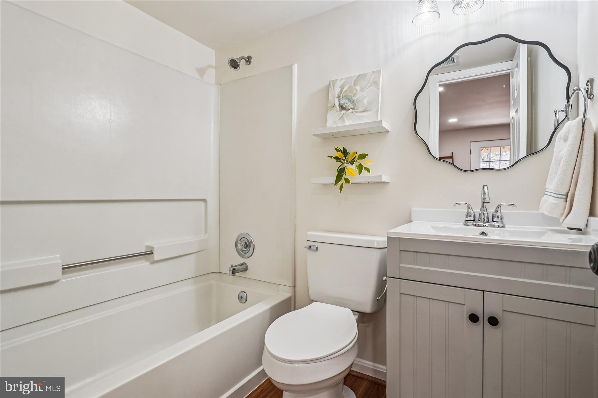 5146 Spring Branch Boulevard Dumfries, VA 22025 - Photo 23 of 38 a bathroom with a toilet a sink and mirror