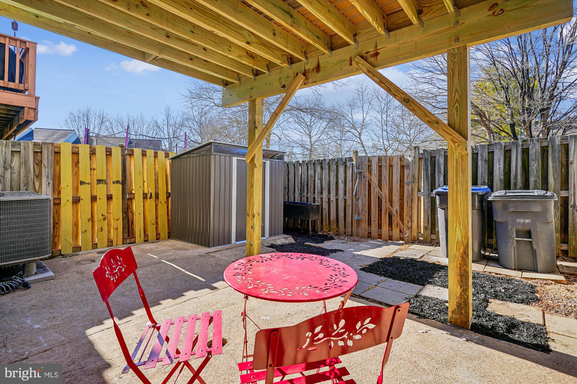 5146 Spring Branch Boulevard Dumfries, VA 22025 - Photo 25 of 38 a view of a patio with a table and chairs