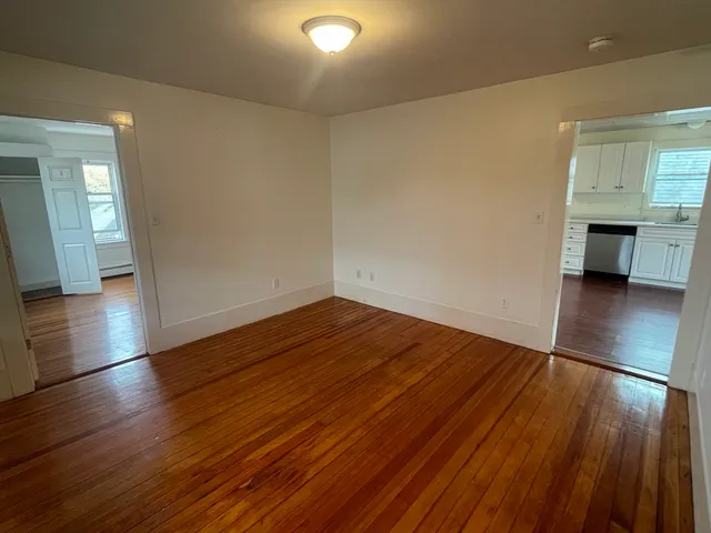 a view of a room with wooden floor and a sink