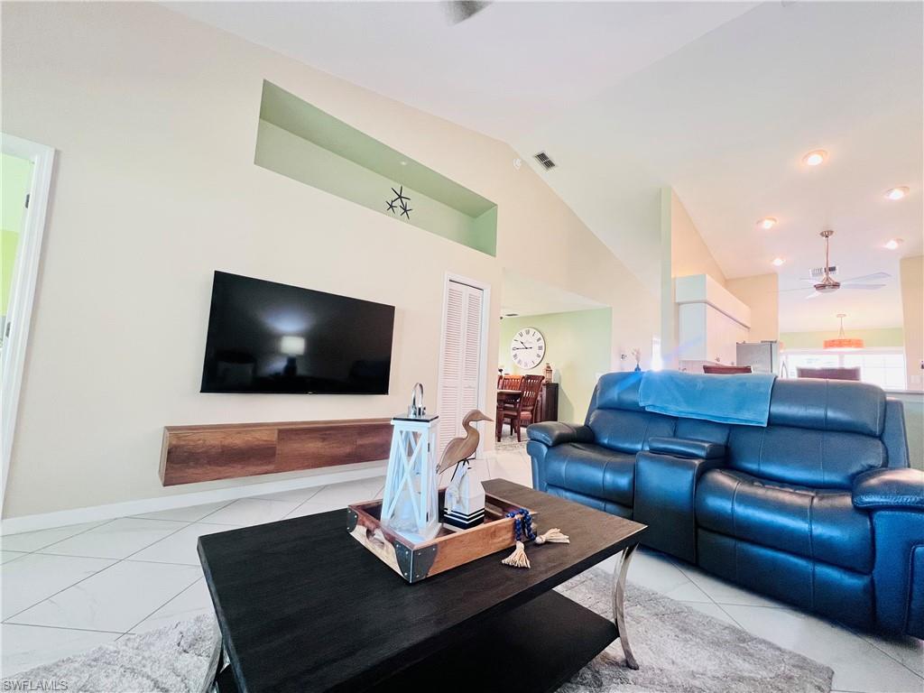 8073 Panther Trail, Unit 1404 Naples, FL 34113 - Photo 11 of 28 a living room with furniture and a flat screen tv