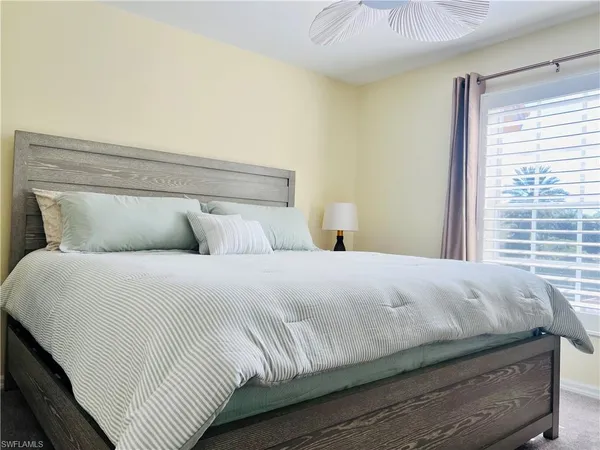 a bedroom with a bed and window