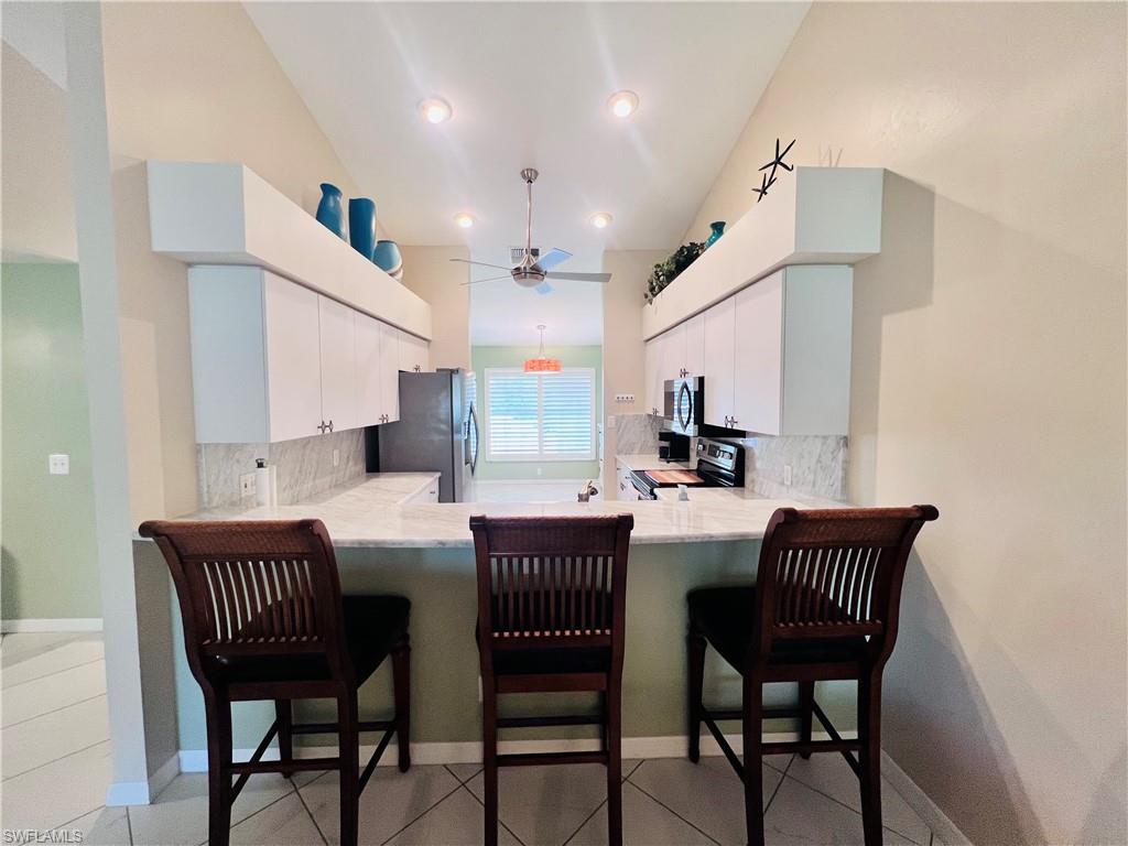 8073 Panther Trail, Unit 1404 Naples, FL 34113 - Photo 4 of 28 a view of a dining room with furniture