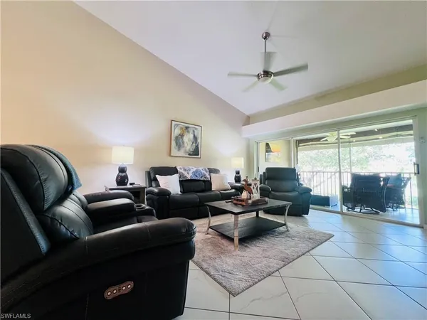 a living room with furniture and a floor to ceiling window
