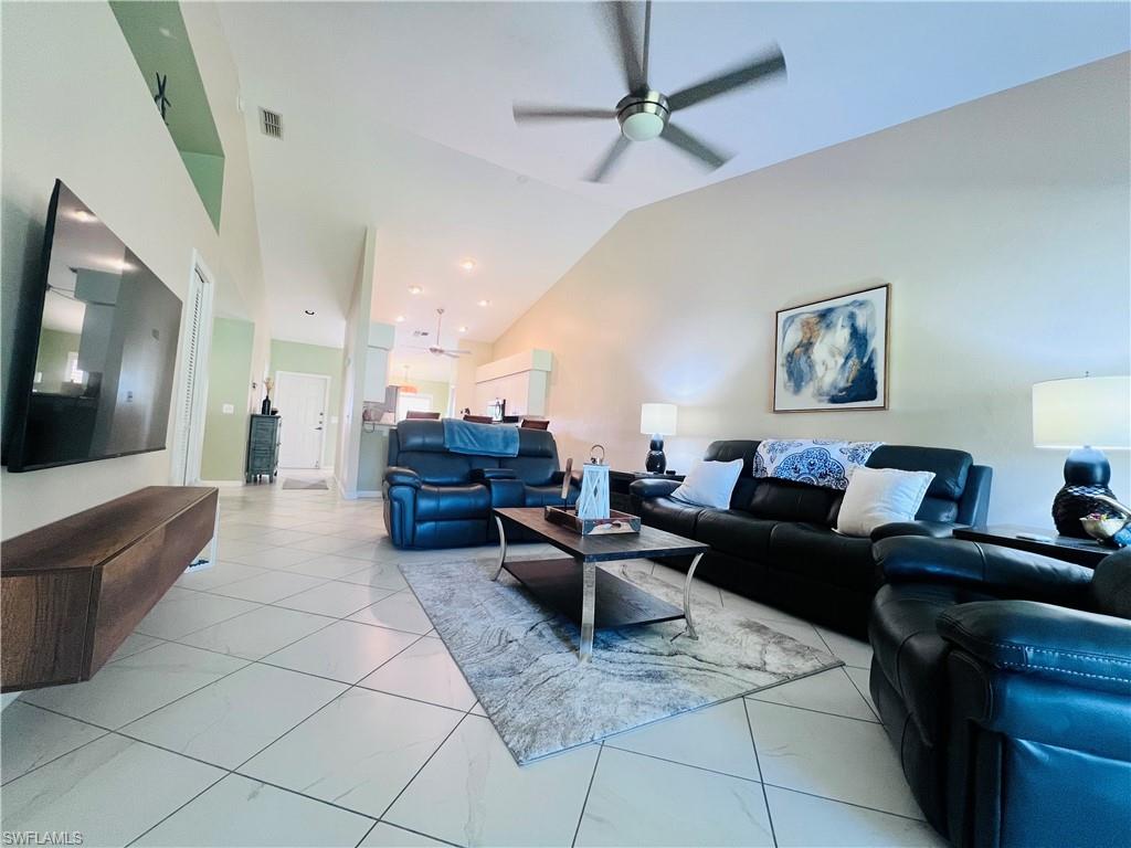 8073 Panther Trail, Unit 1404 Naples, FL 34113 - Photo 10 of 28 a living room with furniture and a flat screen tv