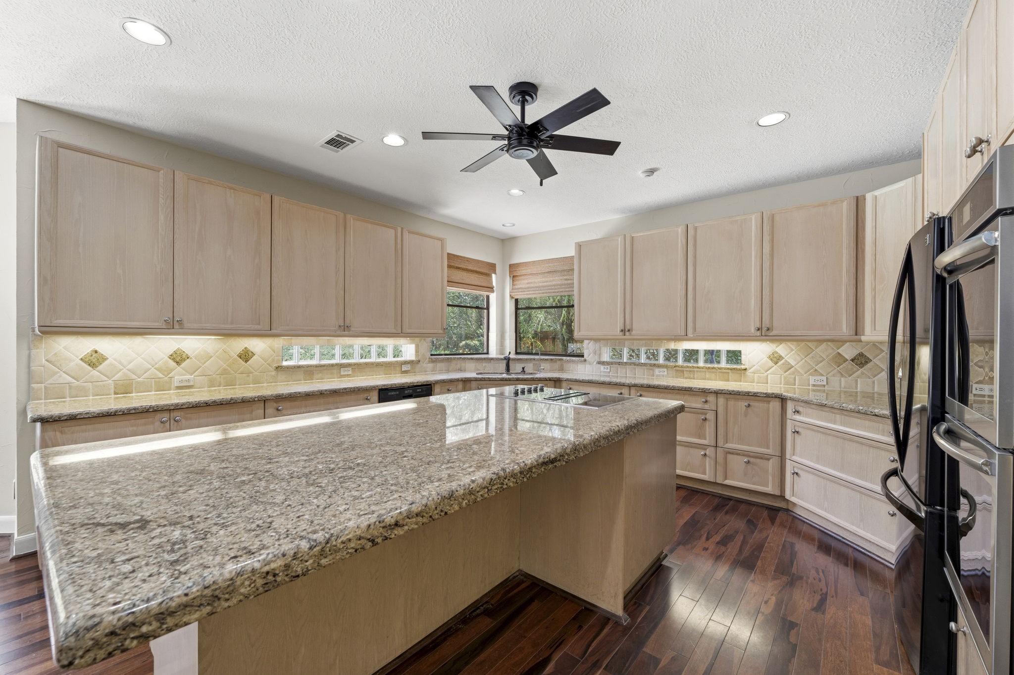 18503 Cabaniss Circle Spring, TX 77379 - Photo 19 of 49 The oversized island provides plenty of prep space and barstool seating, making this kitchen as functional as it is spacious.