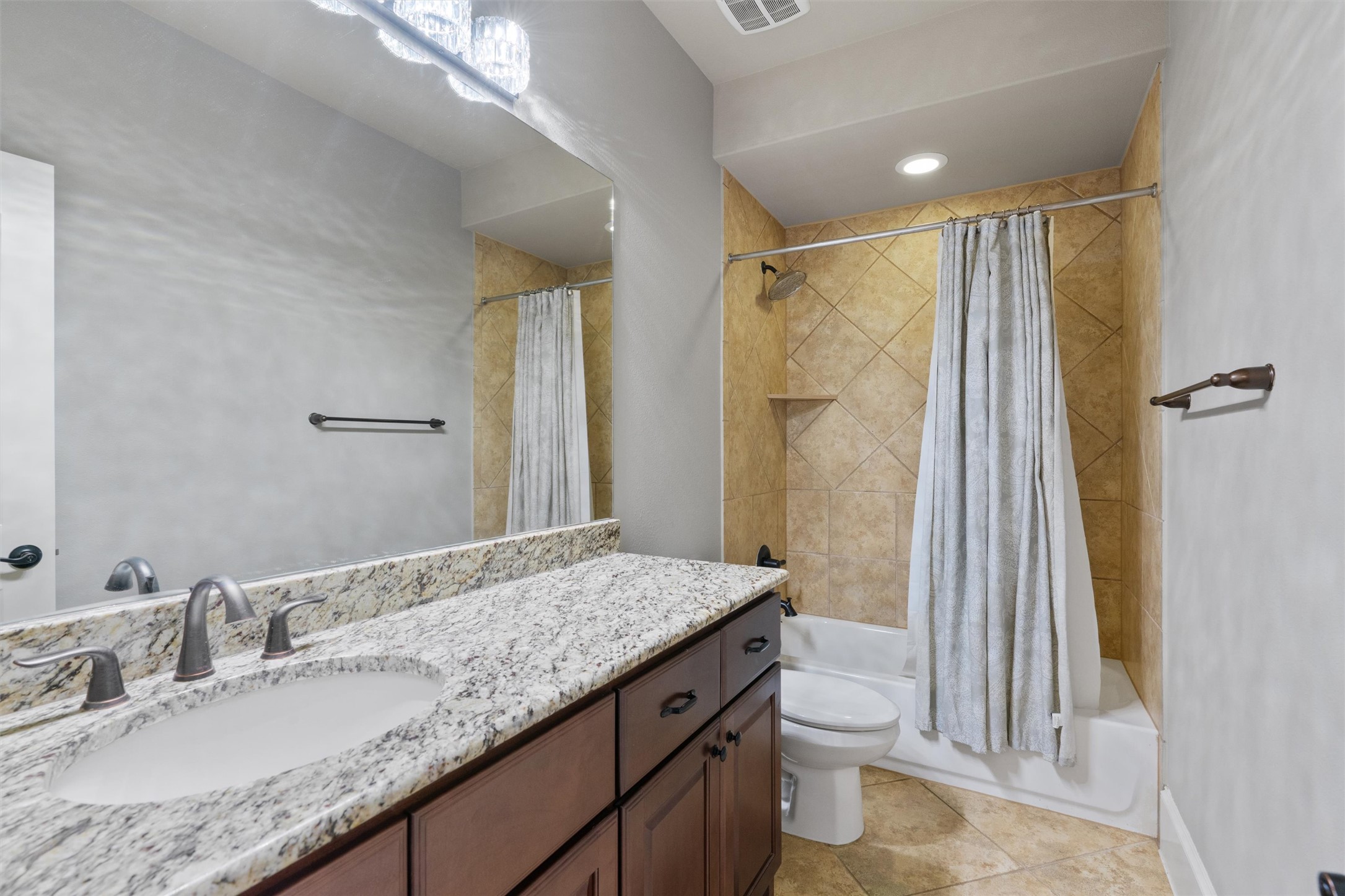 8417 Etienne Cove Austin, TX 78759 - Photo 23 of 35 Granite counters and tiled shower enclosure highlight this well-appointed bathroom.