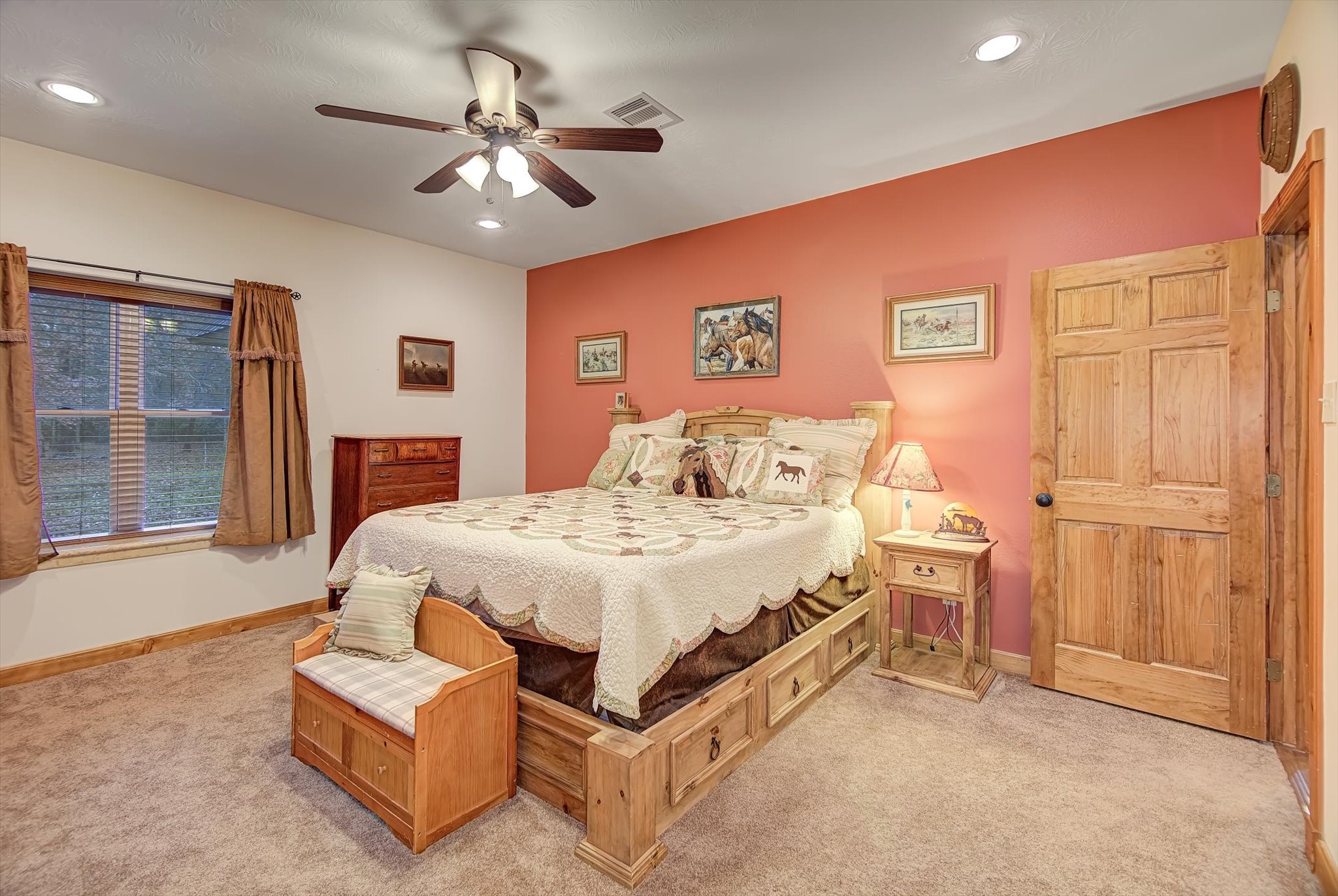 20205 Highway 146 Liberty, TX 77575 - Photo 19 of 50 a spacious bedroom with a bed and a chandelier