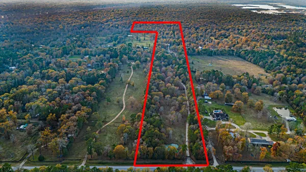 a kitchen with stainless steel appliances granite countertop a stove top oven a refrigerator a sink a dining table and chairs with wooden floor