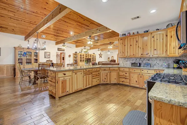 a kitchen with a sink window and cabinets