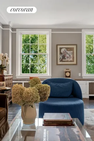 a living room with furniture a chandelier and a window