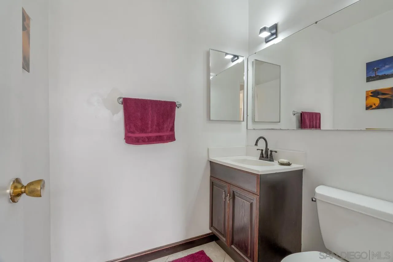 4530 Vandever Avenue, Unit 6 San Diego, CA 92120 - Photo 11 of 25 a bathroom with a toilet a sink and mirror