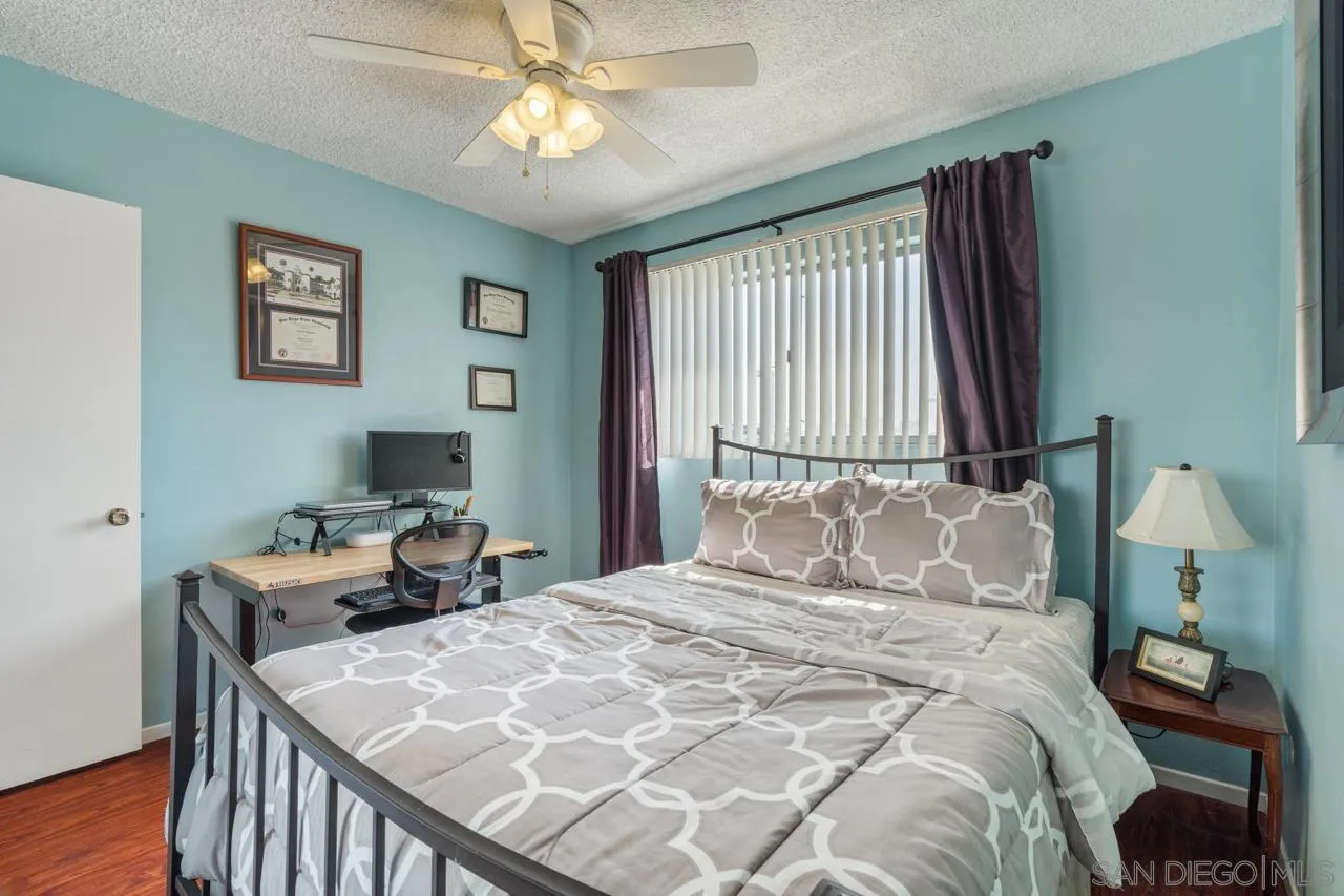 4530 Vandever Avenue, Unit 6 San Diego, CA 92120 - Photo 14 of 25 a bedroom with a bed and a table