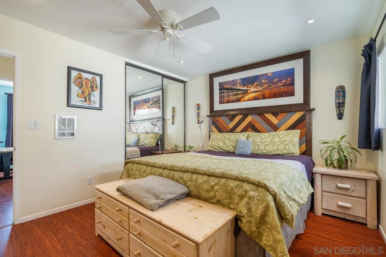 4530 Vandever Avenue, Unit 6 San Diego, CA 92120 - Photo 18 of 25 a bedroom with a bed and wooden floor
