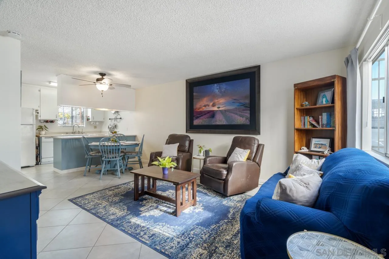 4530 Vandever Avenue, Unit 6 San Diego, CA 92120 - Photo 2 of 25 a living room with furniture a rug and a bookshelf