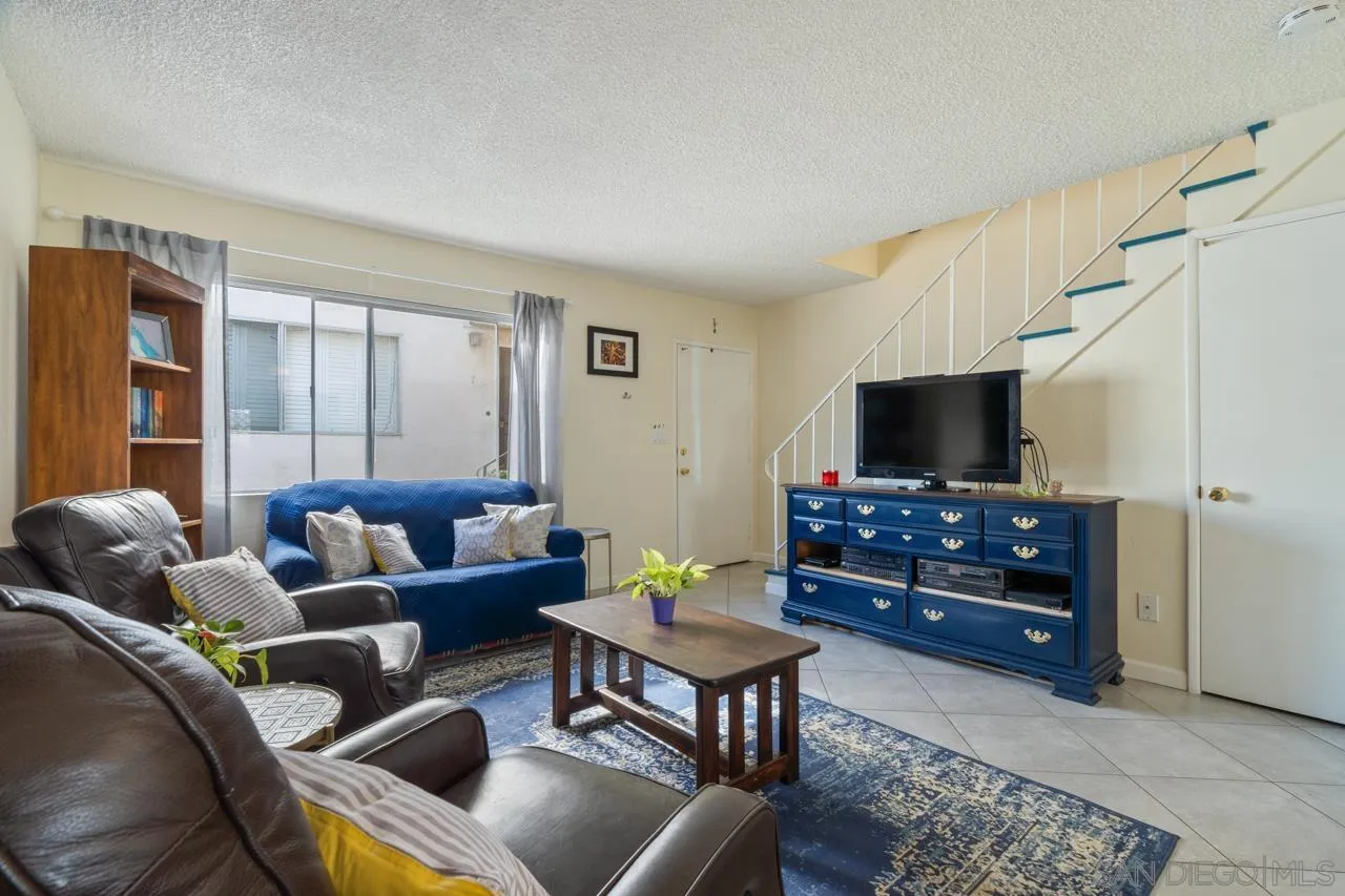 4530 Vandever Avenue, Unit 6 San Diego, CA 92120 - Photo 3 of 25 a living room with furniture and a flat screen tv
