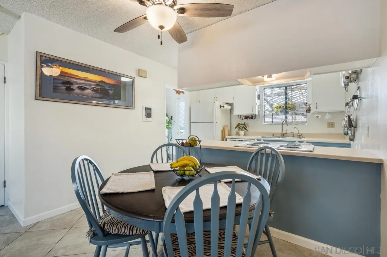 4530 Vandever Avenue, Unit 6 San Diego, CA 92120 - Photo 4 of 25 a dining room with furniture a chandelier and wooden floor
