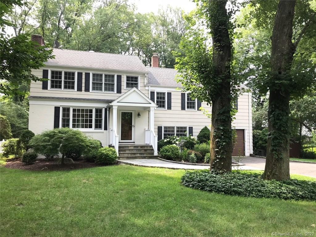 4 Lone Pine Lane Westport, CT 06880 - Photo 1 of 1 a front view of a house with a yard and trees
