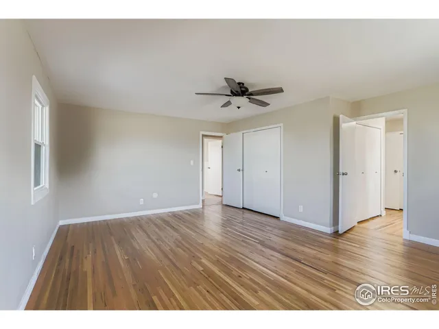 a living room with a bed furniture and a window
