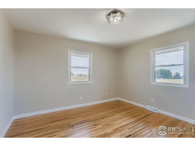 a view of empty room with wooden ceiling