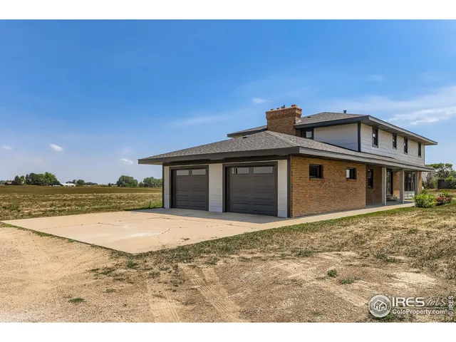 a view of a house with yard and mountain view