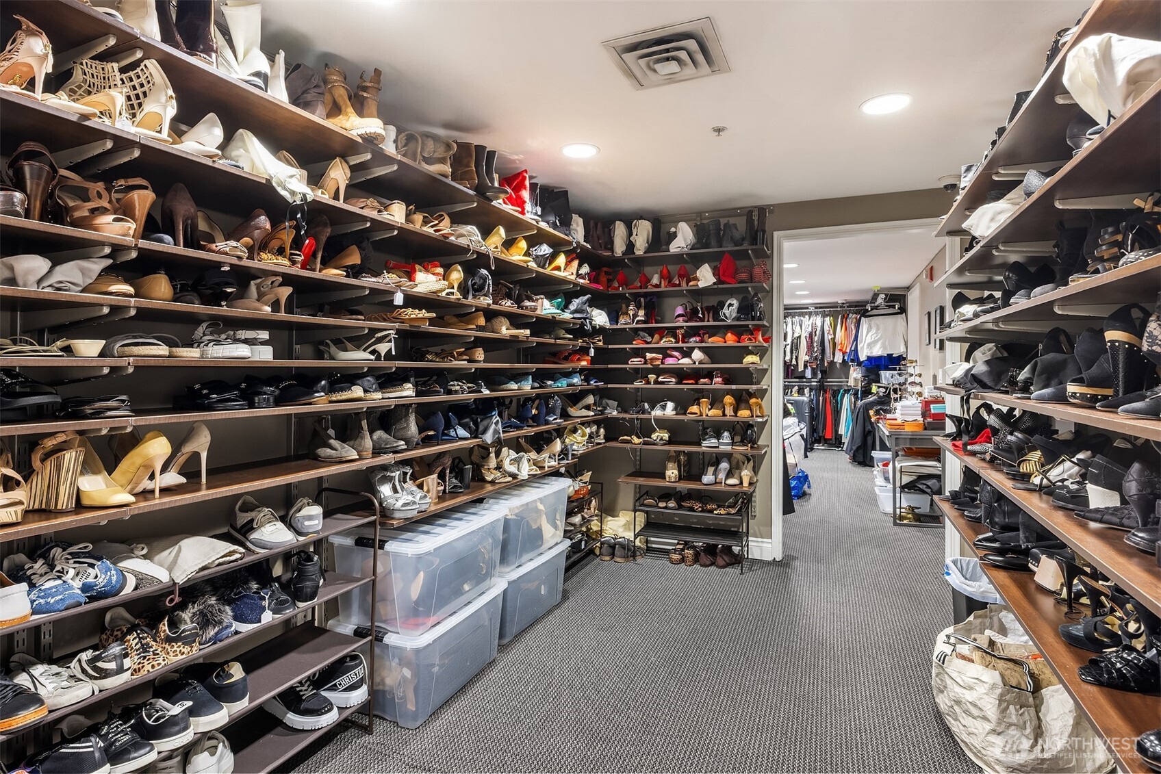 1420 Terry Avenue, Unit OU Seattle, WA 98101 - Photo 7 of 12 a view of walk in closet with clothes and shoes