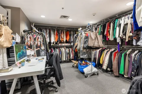 a view of walk in closet with clothes