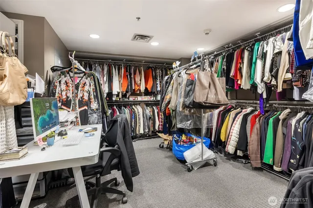 a view of walk in closet with clothes