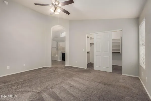 a view of an empty room with a ceiling fan