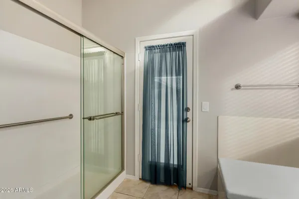 a bathroom with a granite countertop sink double vanity and a mirror