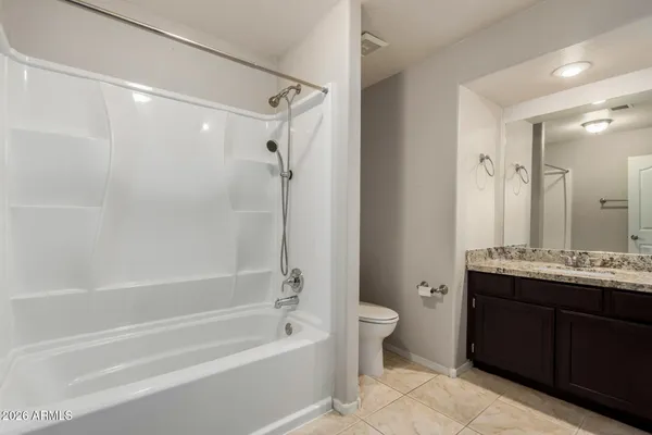 a bathroom with a bathtub a sink a toilet a vanity and shower