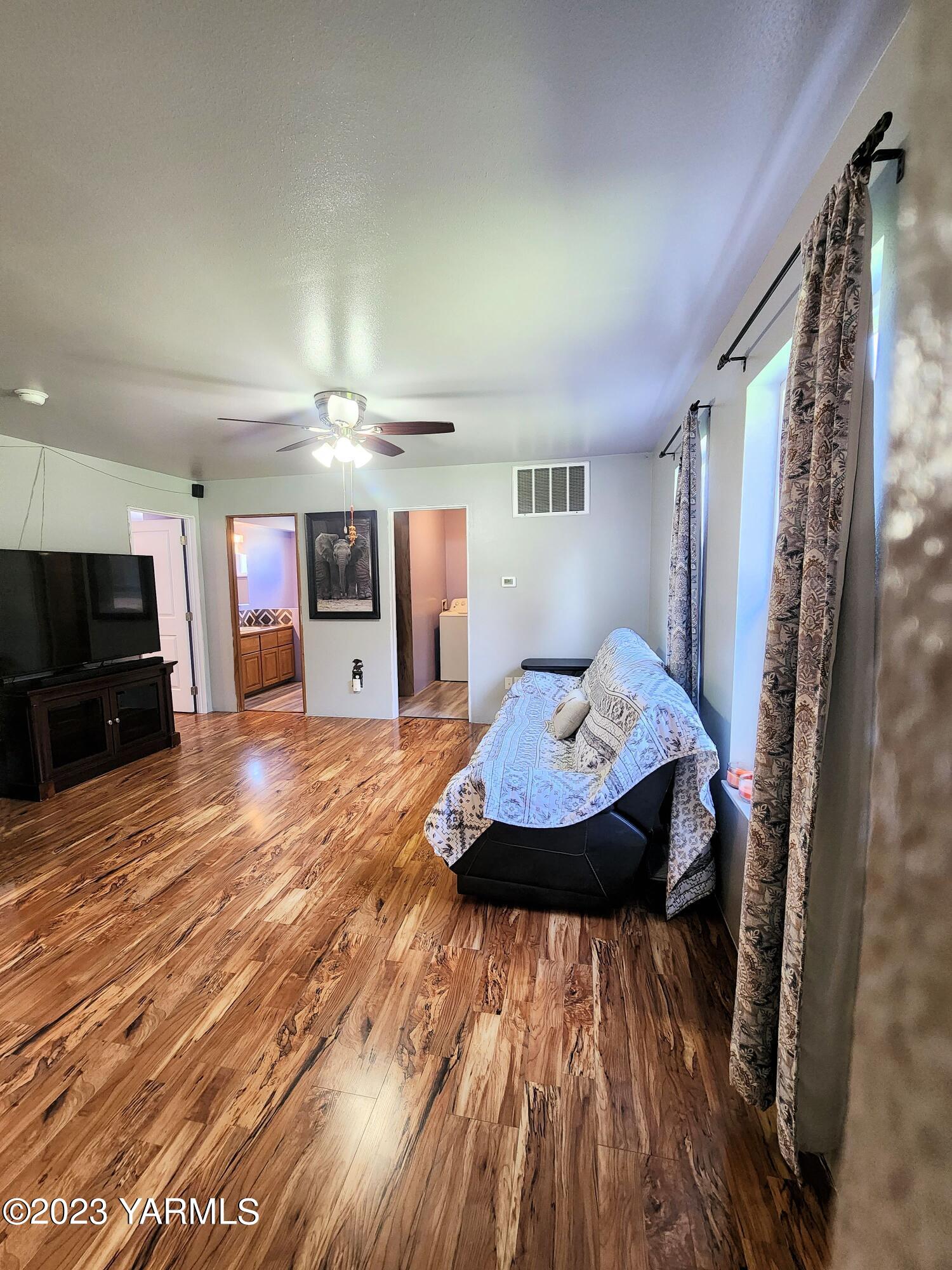 231 Taylor Loop Road Selah, WA 98942 - Photo 8 of 18 a view of a hallway with wooden floor and furniture