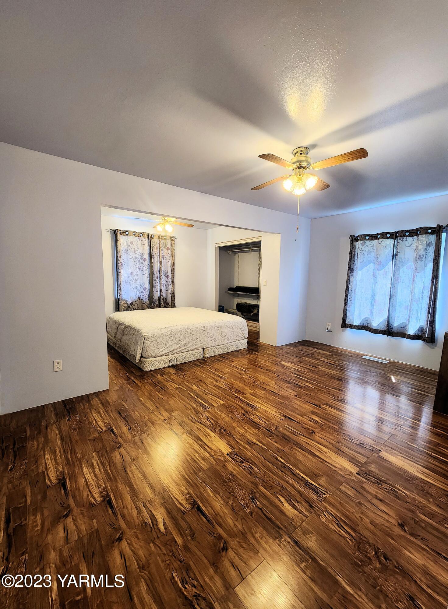 231 Taylor Loop Road Selah, WA 98942 - Photo 9 of 18 a bedroom with a bed and a chandelier