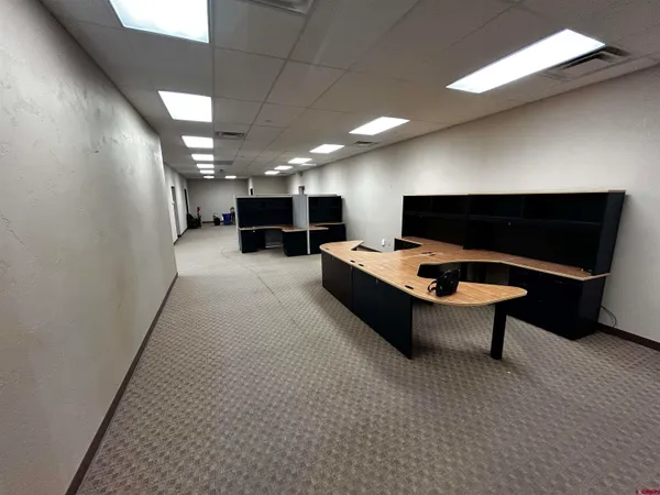 a lobby with furniture and a projector screen