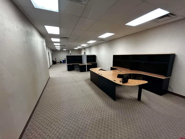 a lobby with furniture and a projector screen