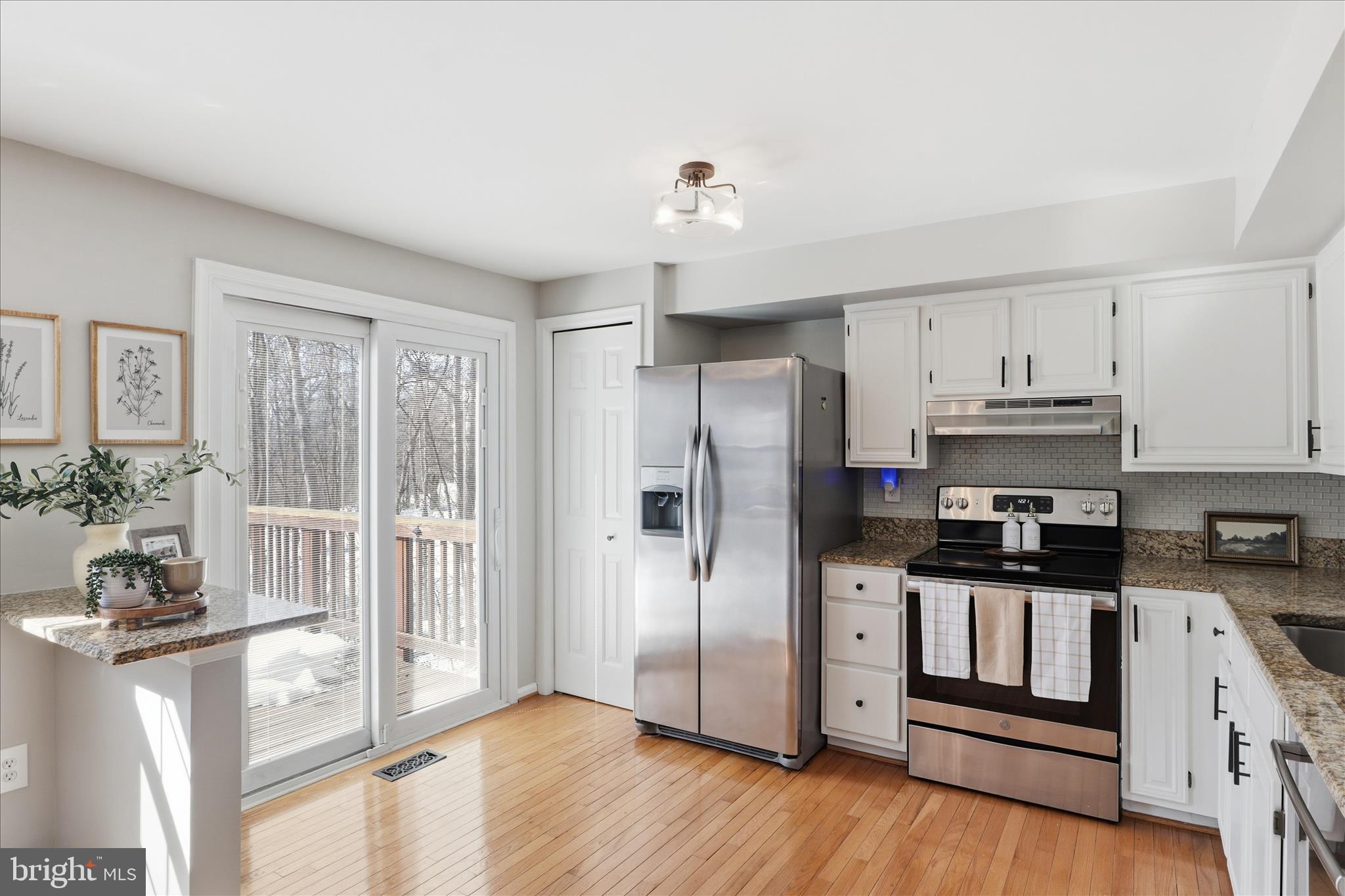 1563 Twisted Oak Drive Reston, VA 20194 - Photo 13 of 47 a kitchen with granite countertop a refrigerator stove and sink