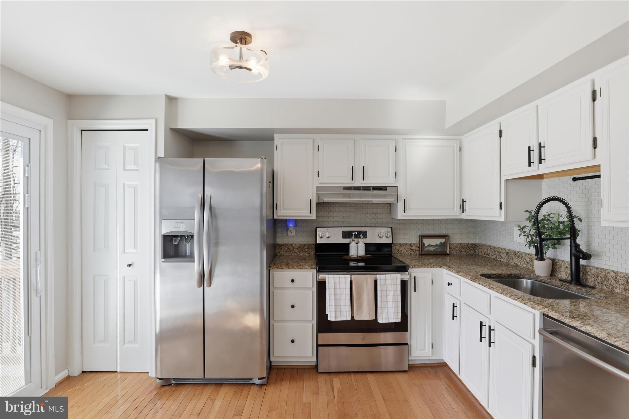 1563 Twisted Oak Drive Reston, VA 20194 - Photo 14 of 47 a kitchen with stainless steel appliances a refrigerator sink and cabinets