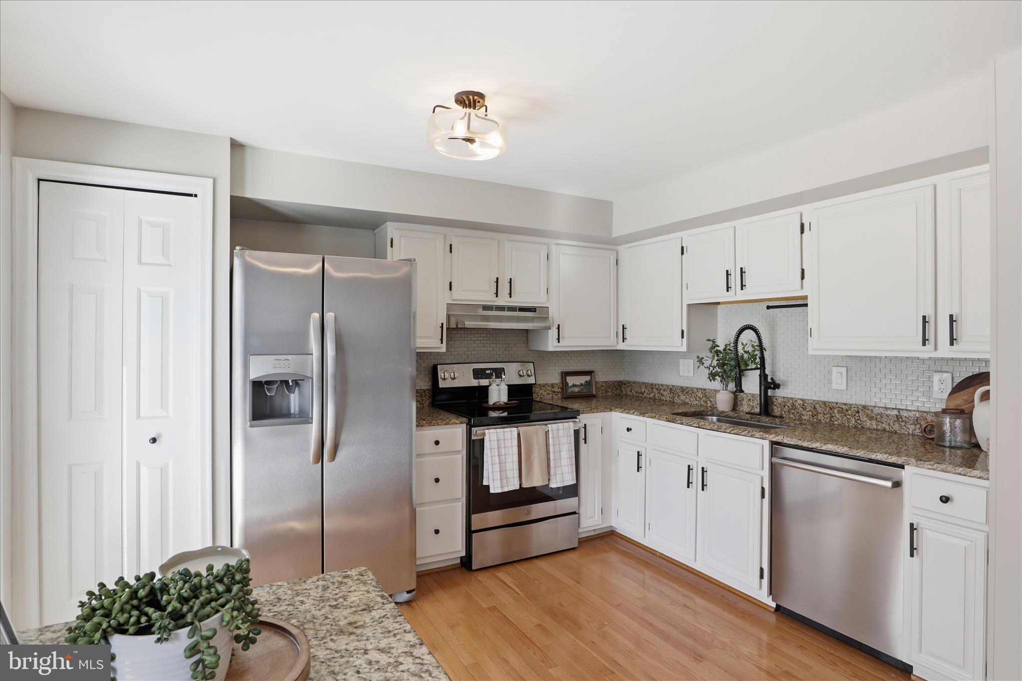 1563 Twisted Oak Drive Reston, VA 20194 - Photo 15 of 47 a kitchen with stainless steel appliances granite countertop a refrigerator and a stove top oven