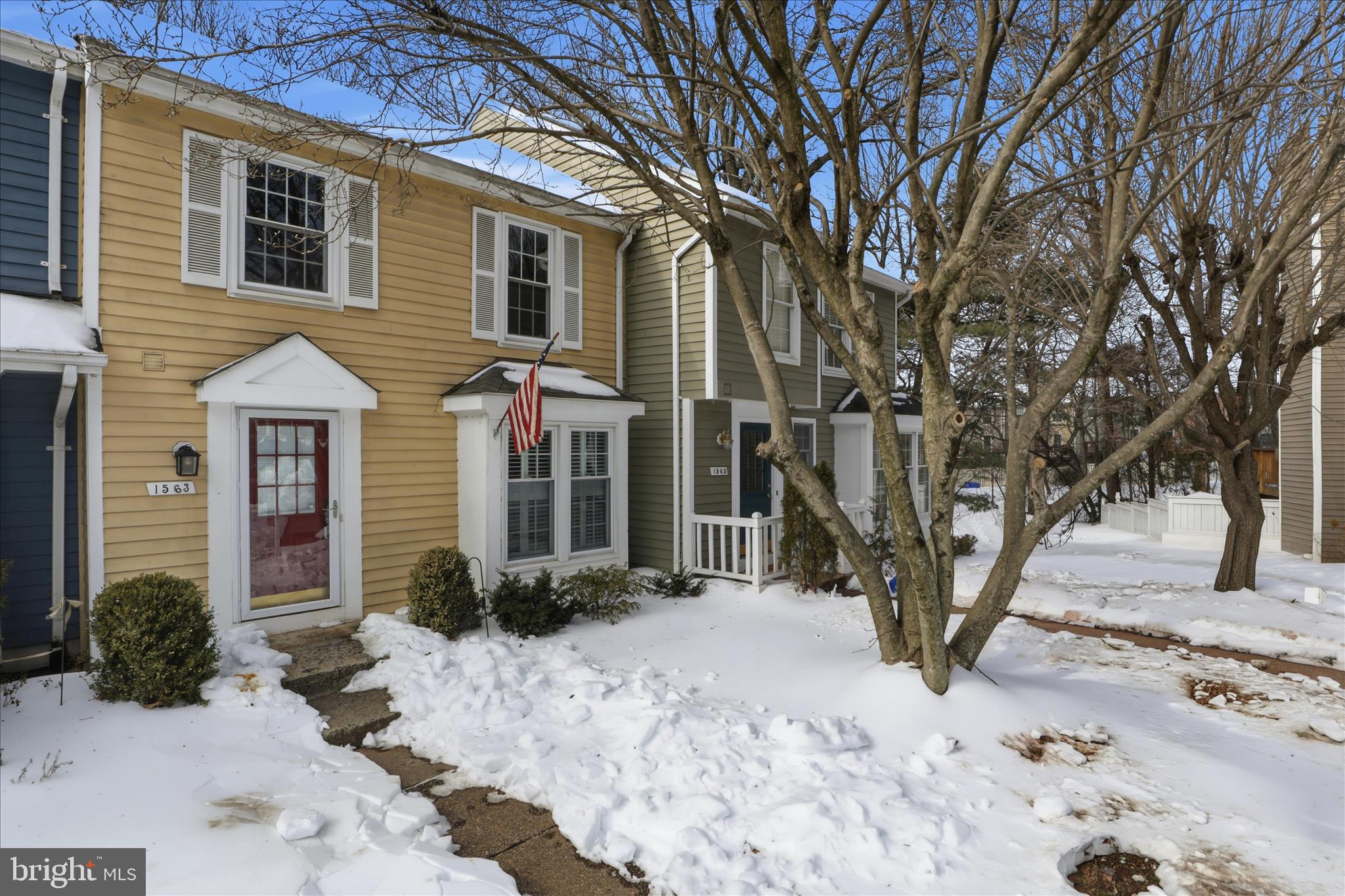 1563 Twisted Oak Drive Reston, VA 20194 - Photo 3 of 47 a front view of a house with a yard covered in snow