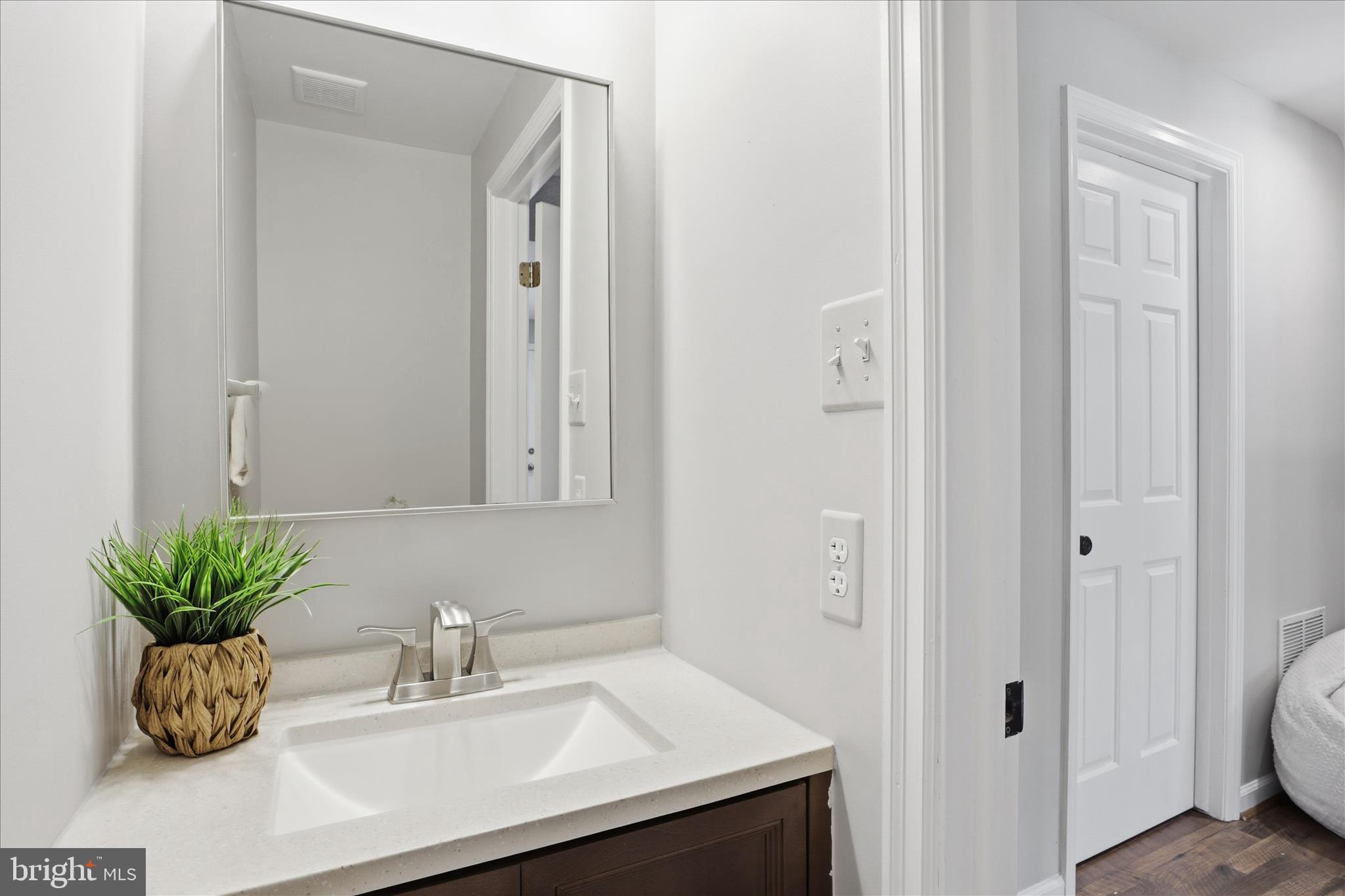 1563 Twisted Oak Drive Reston, VA 20194 - Photo 34 of 47 a bathroom with a sink a potted plant and a toilet