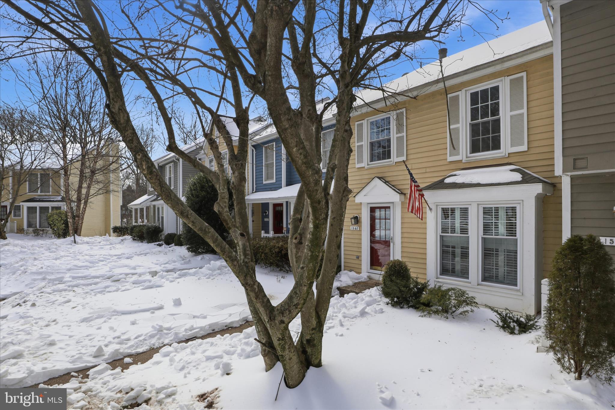 1563 Twisted Oak Drive Reston, VA 20194 - Photo 5 of 47 a front view of a house with a yard covered in snow